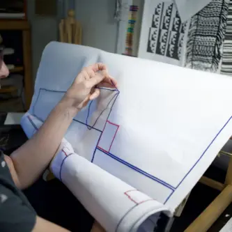 Artist Heather Schulte stitching in her studio