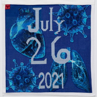Photo by Wes Magyar Cross stitch embroidery with "July 26 2021" down the middle. A human heart, two COVID virus images, and a set of lungs are embroidered in blue threads in behind the lettering. The background is royal blue. A red square is stitched in the top left corner with a small heart shape inside.